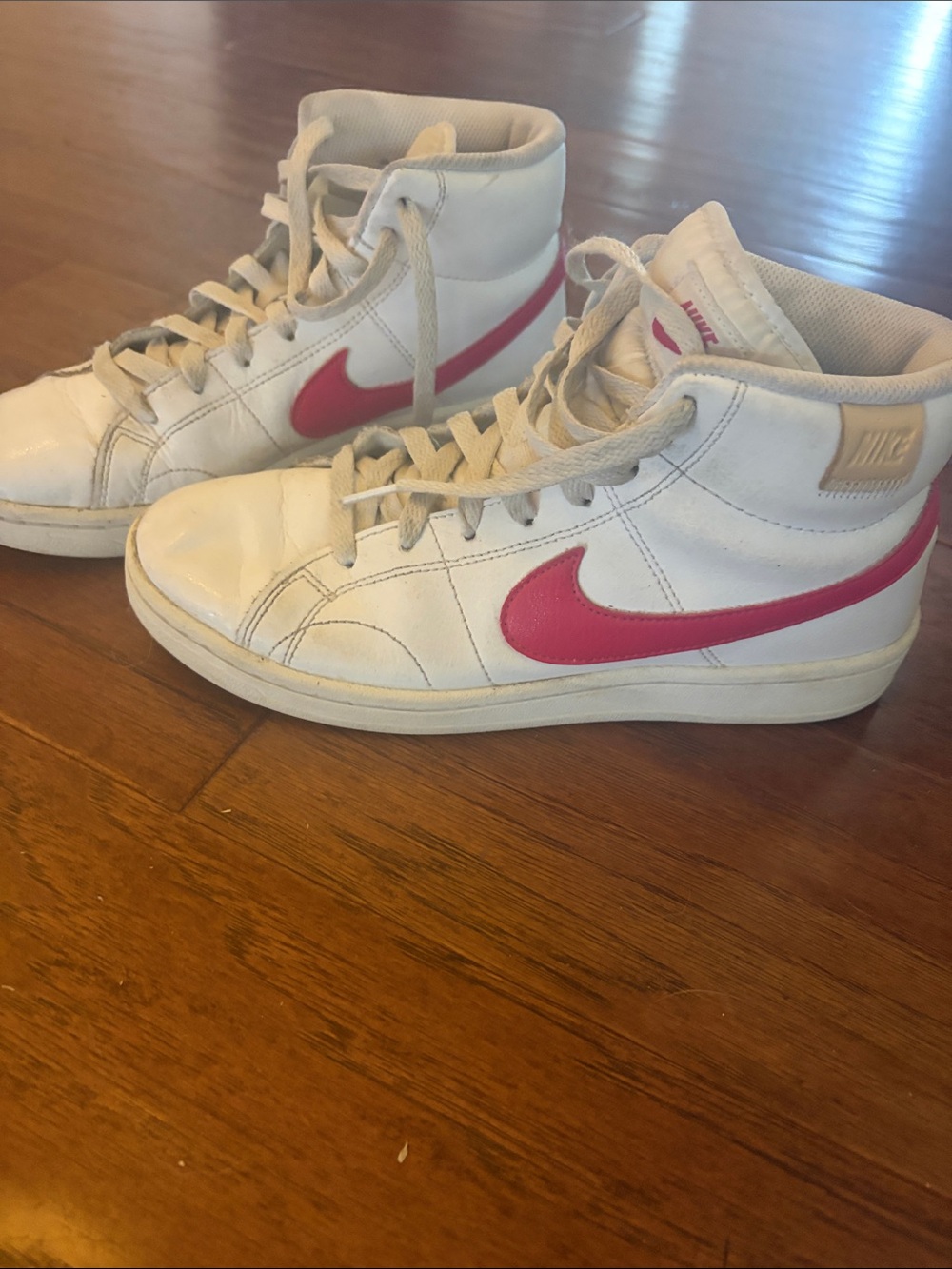 Nike White High-Top Sneakers with Pink Swoosh